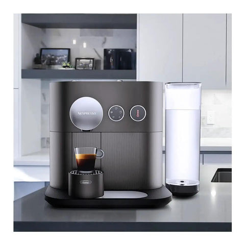 Prime Smart Espresso Machine Pulling Killer Shots On The Fly With Bluetooth App Sync Rotating Dial High Pressure Pump And Zero Hassle Daily Cleaning In Sleek Anthracite Grey with coffee cup.
