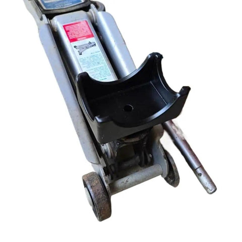 Close-up of a bottle jack with a black Bottle Jack Axle Saddle Adapter For 2 Inch And 3 Inch Axle Tubes attached, showing durable steel construction.