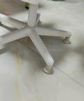 Close-up of an office chair with Bell Glides High Profile 2.5 Inch 5 Pack White for Carpet Replacement instead of wheels.