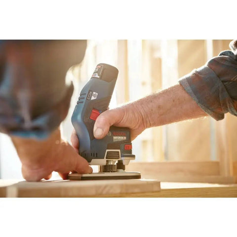 Person using Lightweight 12V Max EC Brushless Palm Edge Router Bare Tool for precise trim work on a wooden surface.
