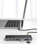 Sleek Usb C Docking Station For Triple Monitors With Usb 3.0 Ports And Dual Card Slots In Heavy Duty Aluminum Build connected to a laptop.
