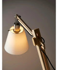 Close-up of Walden Floor Lamp with natural wood body, satin steel base, off-white poly cotton bell shade, adjustable height from 53 to 61 inches