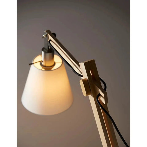 Close-up of Walden Floor Lamp with natural wood body, satin steel base, off-white poly cotton bell shade, adjustable height from 53 to 61 inches