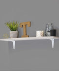 White Powder Coated Shelf Brackets Set 10 Inch By 12 Inch Four Pack Heavy Duty Wall Mount Brackets With 150 Lbs Weight Capacity Pre Drilled Holes For Easy Mounting Durable Support For Home Shelves holding a decorated shelf