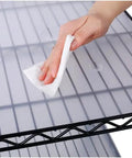 Person cleaning the waterproof shelf mat of a Heavy Duty Seven Tier Wire Shelving Rack Delivering A Ridiculous 2450 Pound Weight Capacity And Rock Solid Metal Construction For Garage Storage Setup.