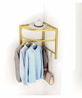 Space Saving Corner Clothes Rack For Laundry Room And Closet, mounted in corner holding shirts and hat, gold finish.