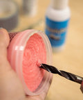 High-Performance Pro-Grade Synthetic Lubricant Paste for MQL Applications in use with drill bit, pink paste, 12 Oz