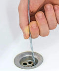 Hand using Pro Grade 10 Foot Metal Drain Cleaner and Clog Remover with Flexible Drain Snake in a sink drain.