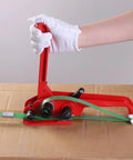 Heavy Duty Green Pet Strap Roll With Zero Hassle Tensioner And Peel Seals, hands using red tensioner on green strap