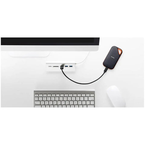 1TB Extreme Pro Portable SSD connected to computer, USB-C cable visible, rugged aluminum build, IP65 water and dust resistant