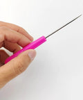 Pro Grade 36 Piece Scriber Needle Kit For Cake Decorating Featuring Stainless Steel Tips And Colorful Plastic Grips, sharp needle in hand.