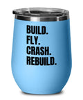 Light blue vacuum insulated stemless wine glass with lid, stainless steel, powder coated, features 'BUILD. FLY. CRASH. REBUILD.' text.