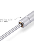 Close-up of soft close gas strut lift support with copper core piston, part of heavy duty zinc plated cabinet lift for lids.