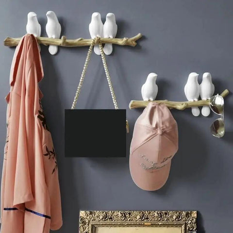 Slick Wall Mounted Hooks For Coats Keys Hats And Towels Housing A Rad Bird Motif in entryway with pink coat and cap.