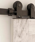 Close-up of heavy duty steel 5.5 Foot Bypass Barn Door Hardware Kit For 33 Inch Double Doors with nylon rollers and T shape hangers.