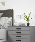 10 Pack Self Stick Push Pull Helper ABS Plastic Wardrobe Handles for cabinets, shown on a grey bedside drawer in a bedroom setting.