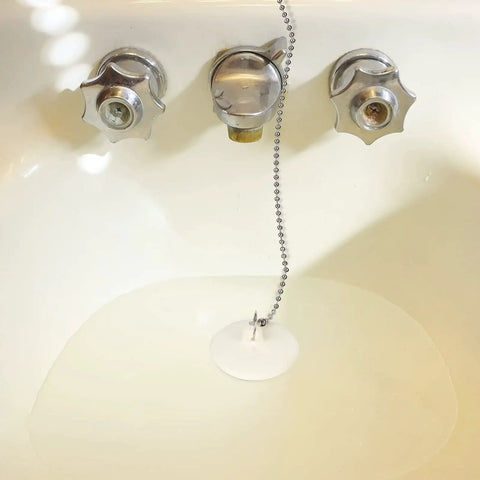 Heavy Hitter 2 Pack Rubber Tub Stopper With Smooth Pull Chain Fits 1 To 1 3 8 Inch Drains in a bathtub with chain attachment.