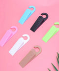 Set Of 6 Thermoplastic Rubber Door Stopper Wedges For Anti Slip Protection And Finger Pinch Prevention, various colors on pink background