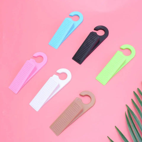 Set Of 6 Thermoplastic Rubber Door Stopper Wedges For Anti Slip Protection And Finger Pinch Prevention, various colors on pink background