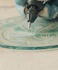 Dremel 729-01 11-piece carving/engraving accessory kit; close-up engraving bit carving on a circular surface