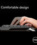 The Beast Mode Full Size Mechanical Gaming Keyboard Delivering Snappy Keystrokes With Dynamic Rainbow Backlight, Flexible Macro Configuration, Comfy Ergonomic Profile, Tough Braided Cable And Hassle Free Wired Setup For Your Daily Grind Gaming Rig with hands typing.