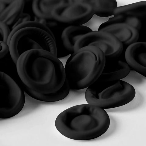 Ace Every Shift With This 400 Pack Black Latex Finger Cots Kit Featuring roll on fingertip guards on a white surface.