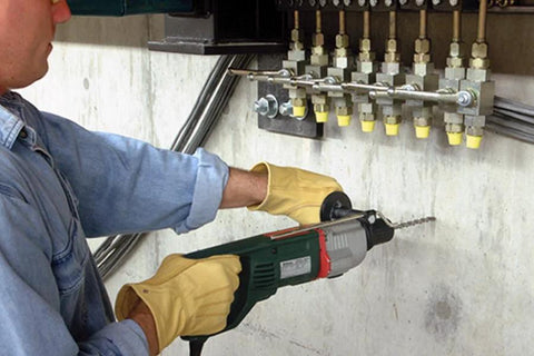 Person using drill with Fixed-Depth Drill Bit MDPL037DIA For Quarter-Inch Drop-In Anchors on concrete wall for accurate installation.