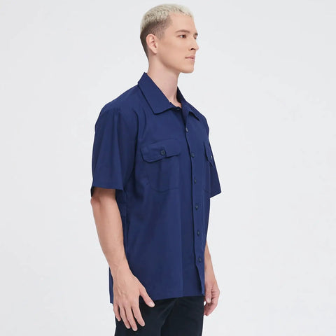 Men's Short Sleeve Work Shirt In Navy Blue Cotton Poly Blend Durable Button Front Uniform Features Double Chest Pockets Built Hella Tough For The Daily Grind And Extra Large Cut on a model from the side angle.