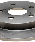 Raybestos 580704R disc brake rotor; automotive part, metal gray with central hub and five bolt holes, front view