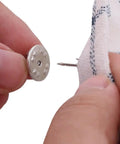 Premium Lock Pin Backs For Lapel Pins Nickel Plated Brass 50 Pack secure metal clutch fasteners being attached to fabric.