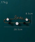 Top Shelf Gold Wrought Iron Letter Wall Hooks Work Like A Charm To Keep Your Entryway Slick And Tidy Rock Solid Heavy Duty Mounting For Keys Coats And Hats Modern Decor on a dark background, featuring a 'love' design.