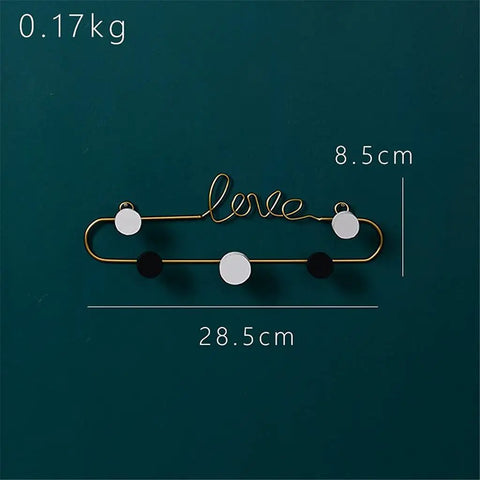 Top Shelf Gold Wrought Iron Letter Wall Hooks Work Like A Charm To Keep Your Entryway Slick And Tidy Rock Solid Heavy Duty Mounting For Keys Coats And Hats Modern Decor on a dark background, featuring a 'love' design.