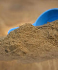 Pigeon Breeding Supplement 500g Kastle Formula with moistened feed and blue scoop on wooden surface