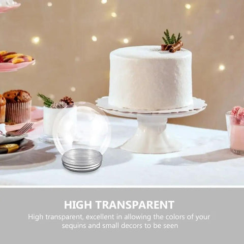 DIY Snow Globe Kit With Ten Clear Plastic Water Globes And Screw Off Caps by a white cake on a table setting