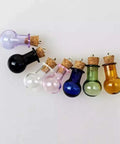 Colorful glass bulb bottles with corks and eye pins for jewelry making