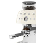 Top Shelf Semi Automatic Espresso Machine With Built In Conical Burr Grinder Dual Thermoblock Heating Precision Controls And Authentic 1950s Retro Vibe In Smooth Cream Finish showing pressure gauge and portafilter.