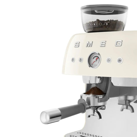 Top Shelf Semi Automatic Espresso Machine With Built In Conical Burr Grinder Dual Thermoblock Heating Precision Controls And Authentic 1950s Retro Vibe In Smooth Cream Finish showing pressure gauge and portafilter.