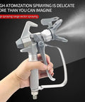 Heavy Duty Airless Paint Spray Gun Packing 3600 Psi With A Wide 517 Tip, held with one hand, spraying smoothly.