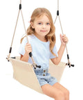 Child sitting on Minimalist Doorway Swing Chair With Heavy Duty Rope For Indoor Outdoor Fun, Comfortable U Shape Ergonomic Design, Beige