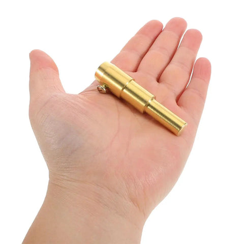 Hand holding small brass tool from Auto Body Dent Repair Kit With Puller Rings And Iron Shaping Tabs High Efficiency Sheet Metal Dent Removal Tools