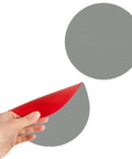 Hand holding 2-Pack 7 Inch Round Door Knob Wall Protectors, Premium Self-Adhesive Rubber Bumpers In Gray For Wall Protection