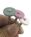 Close-up of three colored aluminum oxide wheels from Rotary Grinding Stone Set 50 Pcs With Eighth Inch Shank Aluminum Oxide Mounted Grinding Wheels
