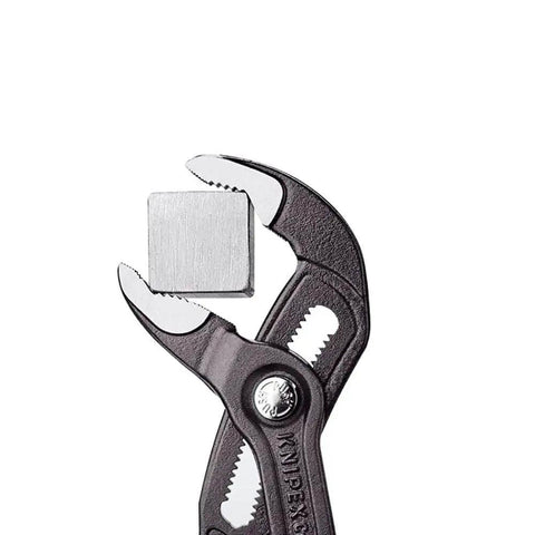 Heavy Duty 22 And A Half Inch Cobra Style Water Pump Pliers And Pipe Wrench with Box Joint gripping a metal square