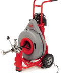 Top Notch Auto Feed Drain Cleaning Machine With Smooth Operator Cable Control And Three Quarter Inch Pigtail Plus Nine Piece Cutter Set Killer Clearance For Stubborn Clogs And Messy Pipes on a red stand with wheels.
