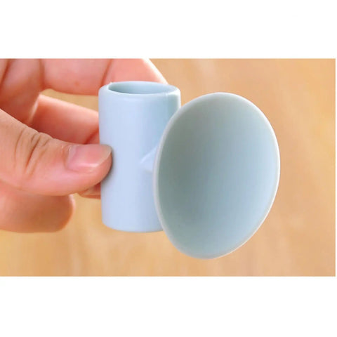 Person holding a Silicone Suction Cup Door Stopper Wall Protector With Noise Reduction Pad in blue