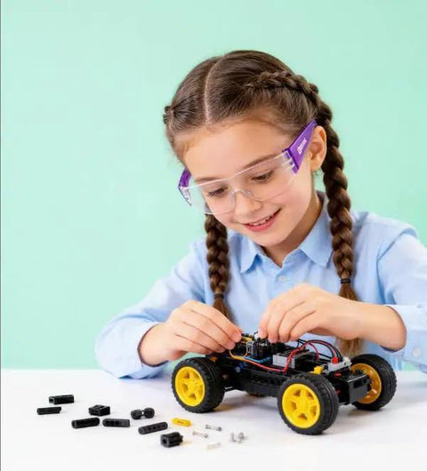 Girl using Six Crew Pack Youth Safety Glasses With Anti Fog And Uv400 Tint, assembling a toy car with small parts.