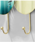 Close-up of Heavy Duty Iron Wall Mounted Coat Hooks And Scarf Organizer With Sleek Geometric Lines, featuring hooks for coats.