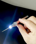 Hand holding LED Weeding Tool Set For Vinyl With Light No Fuss Pin And Hook For Removing Tiny Vinyl Paper And Iron On Projects Cricut