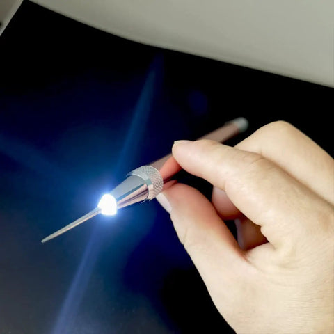 Hand holding LED Weeding Tool Set For Vinyl With Light No Fuss Pin And Hook For Removing Tiny Vinyl Paper And Iron On Projects Cricut
