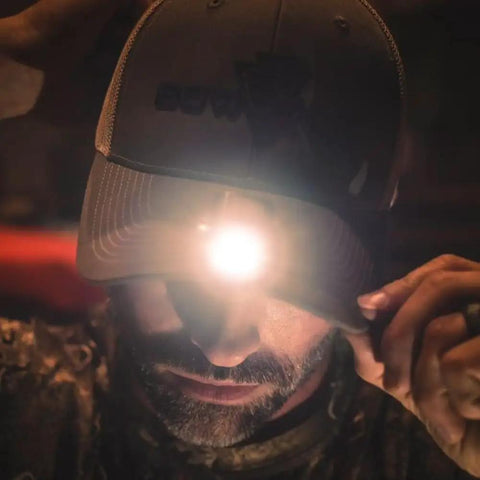 Man wearing PowerCap Hat Clip On Lamp Rechargeable LED Headlamp Hands Free Ultra Bright With 3 Lighting Modes in low light